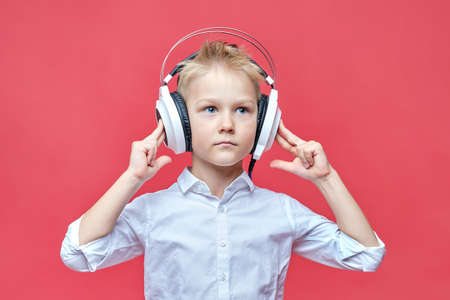 Cute little boy throws up his hands to the sides.の写真素材