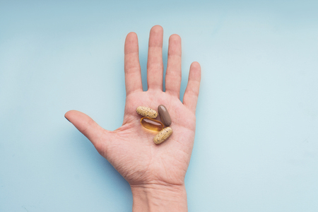 Treatment and pharmacy concept. Colorful pills in the handの写真素材