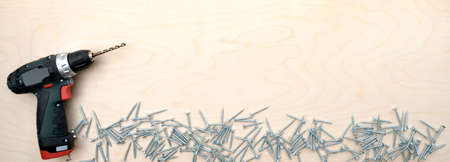 Close up of electric drill and shatterproof drill bits on wooden with copy spaceの写真素材