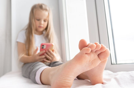 happy little girl is lying at home and smilingの写真素材