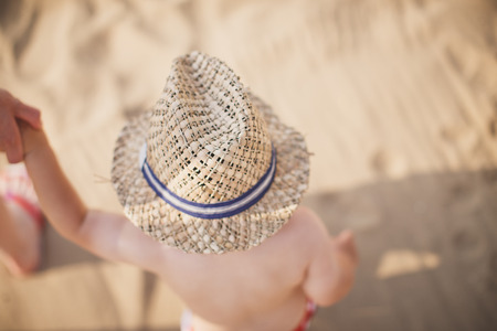 Son with his father walk on the beachの写真素材