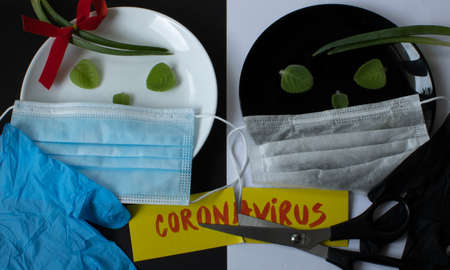 protection from viruses and bacteria in restaurants and cafes. Creative concept, on a plate in the form of eyes with a medical mask, with the inscription cancel quarantineの写真素材