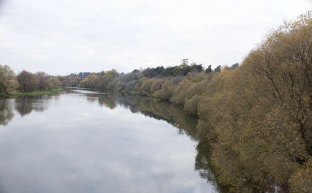 Late autumn. River in the Park on an autumn day, the water looks brownish-yellow,の写真素材