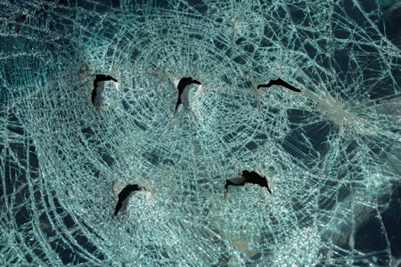 broken in a car accident car windshield with many cracks and holes