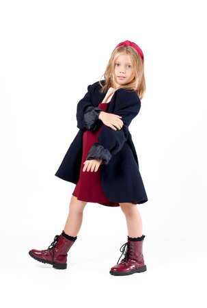 Little girl fashion model wearing stylish oversize jacket posing isolated on white backgroundの写真素材