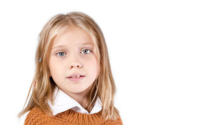 Close up portrait of pretty little blonde girl isolated on white background. Copy spaceの写真素材