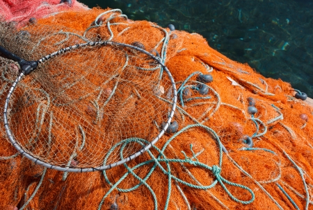 Orange fishing net with floats on close-upの写真素材