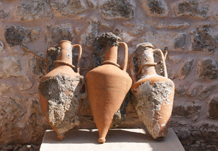Ancient amphoras connected by rope in fortress-museum courtyard in Marmaris, Turkey