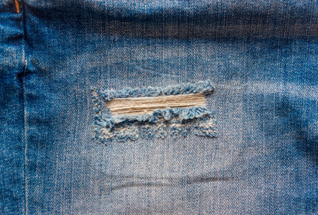 blue faded ripped jeans closeup