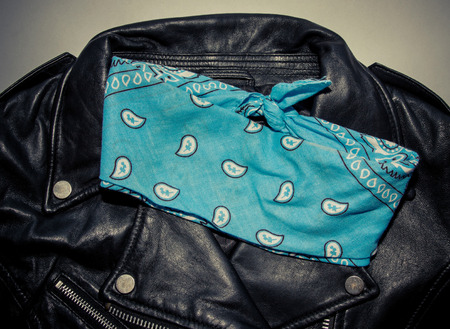 biker black leather jacket and blue bandana. Photo with vintage toning and vignetteの写真素材
