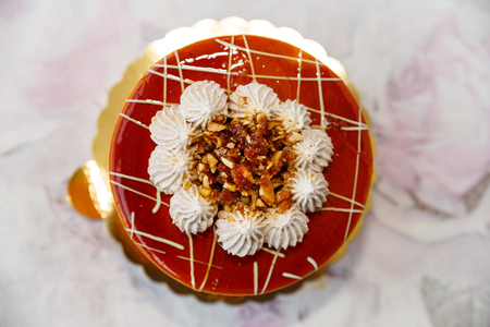 cake with roasted nuts, sheker and caramel, decorated with creamの写真素材