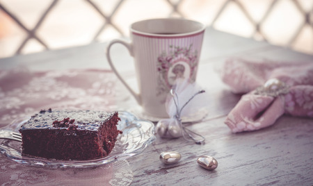 Chocolate brownie cake and coffee on beautiful table with beautiful napkins vintage style. Photo toned with vignetteの写真素材