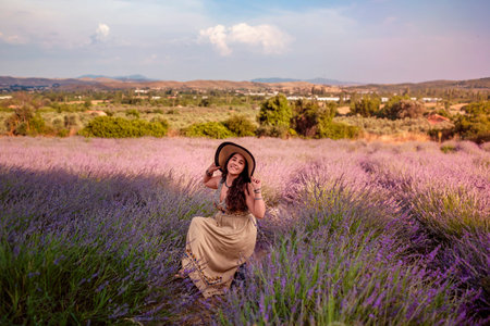 Girl in hat in lavender field in countryside near Izmir, Turkey