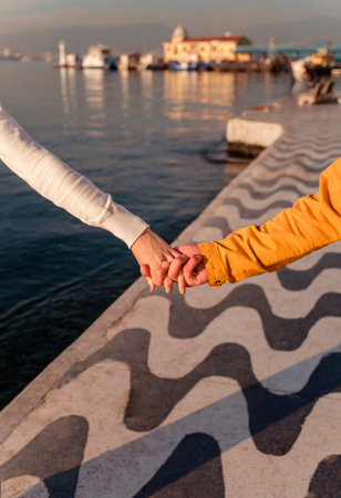 Hands of a couple in love on the background of the embankment in Izmir