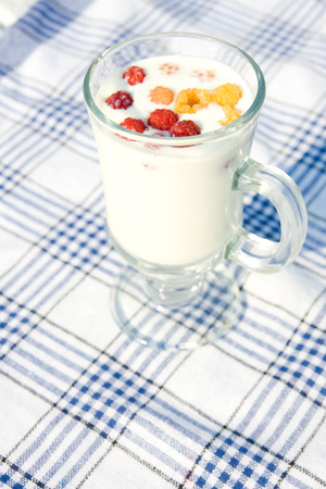 Milk and raspberries in cup の写真素材