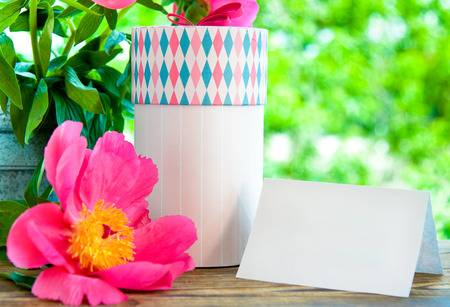 gift and empty card for letter in garden. Focus on card and boxの写真素材