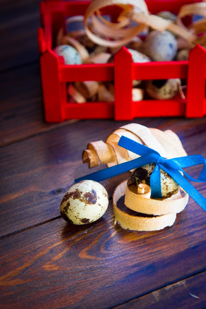 Easter decorations. Quail eggs with bow in boxの写真素材
