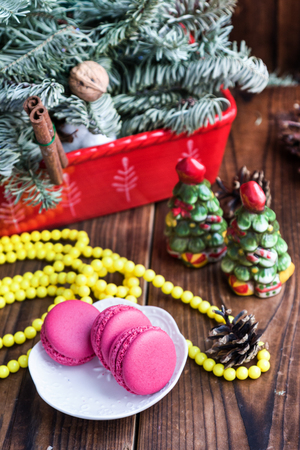 Pink macaroons with christmas decorations on woooden backgroundの写真素材