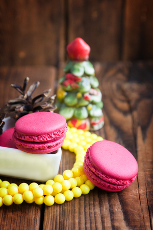 Pink macaroons with christmas decorations on woodの写真素材