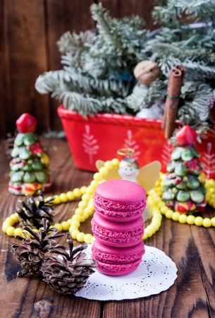 Pink macaroons with christmas decorations on woooden backgroundの写真素材