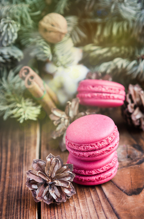 Pink macaroons with christmas decorations on woooden backgroundの写真素材