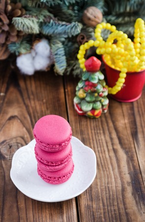 Pink macaroons with christmas decorations on woodの写真素材