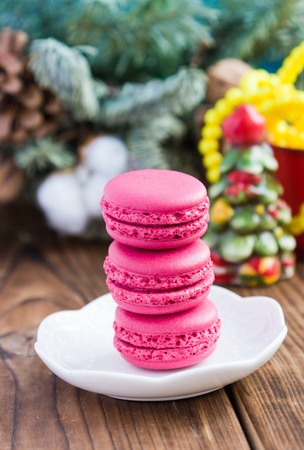 Pink macaroons with christmas decorations on woooden backgroundの写真素材