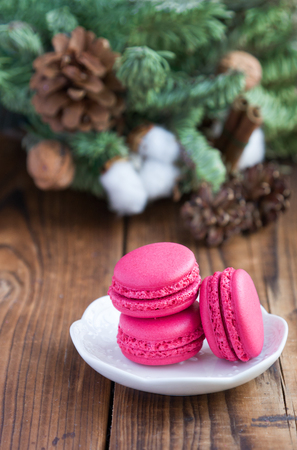 Pink macaroons with christmas decorations on woooden backgroundの写真素材