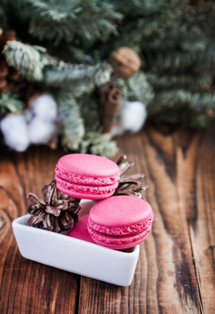 Pink macaroons with christmas decorations on woodの写真素材