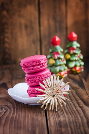Pink macaroons with christmas decorations on woooden backgroundの写真素材