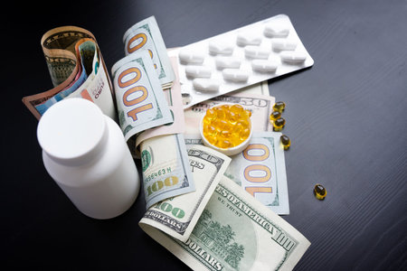 Capsules of fish oil and euro, dollars on black background