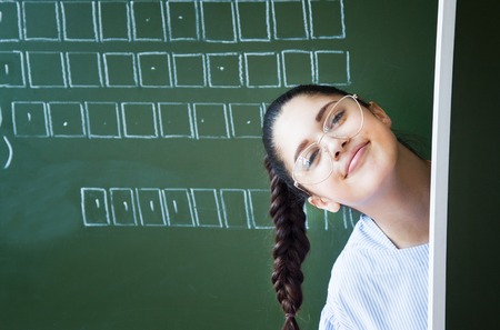 Student stays near blackboardの写真素材