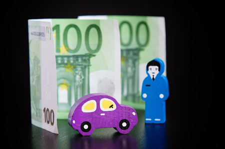 Toy car, euros and businessmen on black backgroundの写真素材