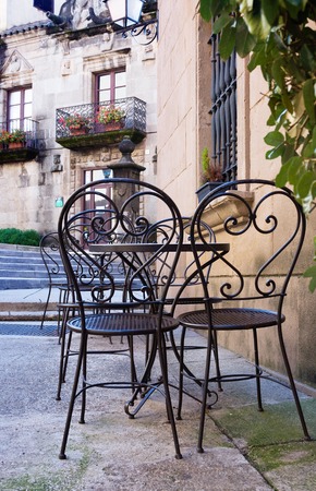 Street cafe with metal tables and chairs in Barcelonaの写真素材
