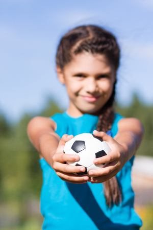Girl with ball. Focus on ballの写真素材