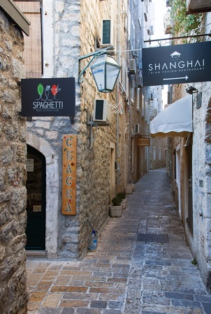 BUDVA, MONTENEGRO - JULY 12, 2015: Narrow street in Budva in morning. Budva among oldest urban settlements of Adriatic coast, UNESCO World Heritage Siteのeditorial素材