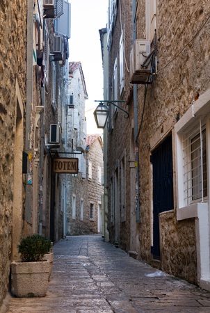 BUDVA, MONTENEGRO - JULY 12, 2015: Narrow street in Budva in morning. Budva among oldest urban settlements of Adriatic coast, UNESCO World Heritage Siteのeditorial素材