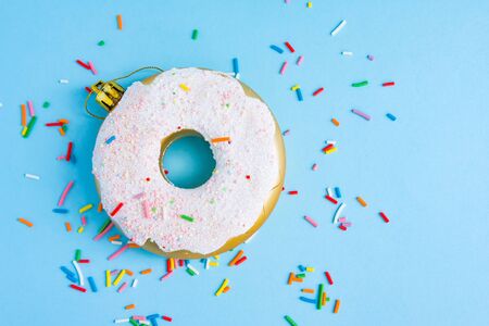 Donut Christmas tree toy and confetti on blueの写真素材