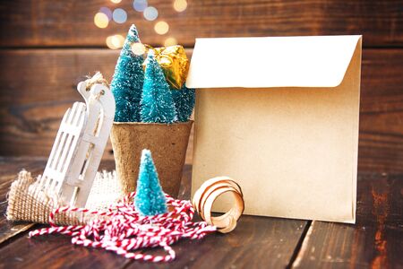 Artificial little Christmas treees in biodegradable peat moss, craft envelope, small sledge and wooden shavings. Eco-friendly New Yearの写真素材