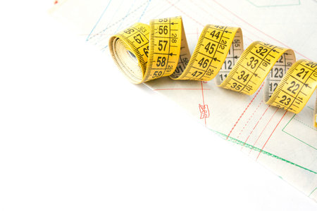 Centimeter tailor's tape and pattern on white background. Sewing accessories and accessories for...