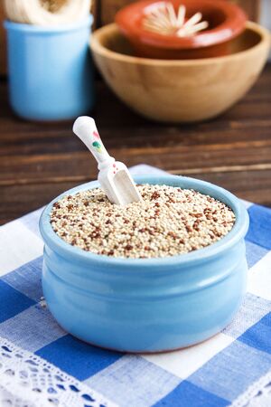 Organic quinoa grains in blue ceramic bowl, Gluten free. Concept Healthy food. Diet. Seeds of Chenopodium quinoa. Selective focusの写真素材