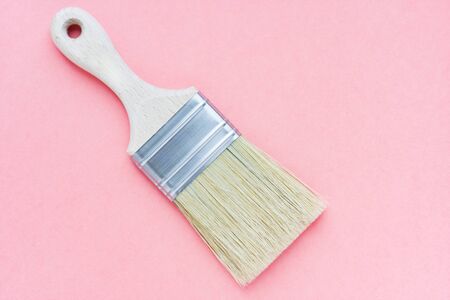 Paint brush with natural bristles for paint and varnish on pink background. House renovation. Hobby. Color therapyの写真素材