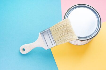 Paint metal round can and new brush on multi-colored background. Focus on brush. House renovation. Hobby. Color therapyの写真素材