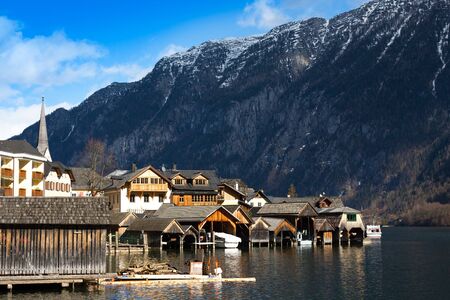 Traditional wooden boat houses in Hallstatt - mountain village at Hallstaetter Lake, Salzkammergut.   old European architecture. It is famous tourist attractionの写真素材
