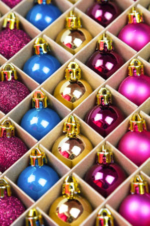 Blue, pink, gold and purple balls for christmas in box. Close up. Prepearing for New Yearの写真素材