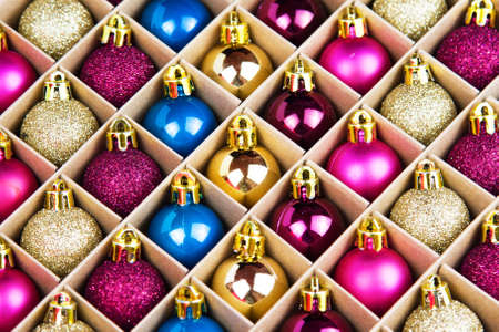 Blue, pink, gold and purple balls for christmas in box. Close up. Prepearing for New Yearの写真素材