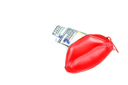 Love for money. Red purse in form of lips and banknotes of one hundred dollars. Women's salary. Selling love. Copy spaceの写真素材