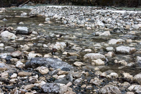 Fast river in mountain gorge. Large stones on banks. Partnachklamm, famous tourist destination. Partnachklamm in Garmisch-Partenkirchen, Bavariaの写真素材
