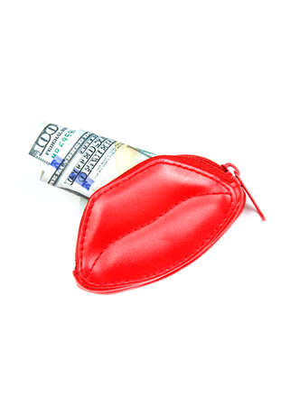 Love for money. Red purse in form of lips and banknotes of one hundred dollars. Women's salary. Selling love.の写真素材
