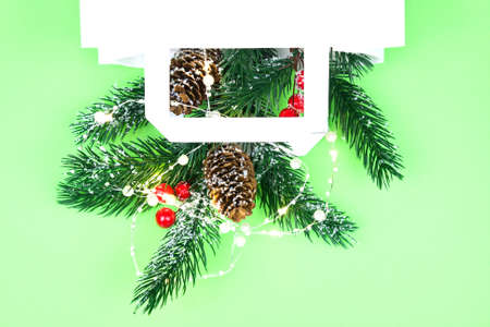 New Year decorations with lights in white paper bag with space for you text. Concept christmas gift, new year sale or delivery.の写真素材